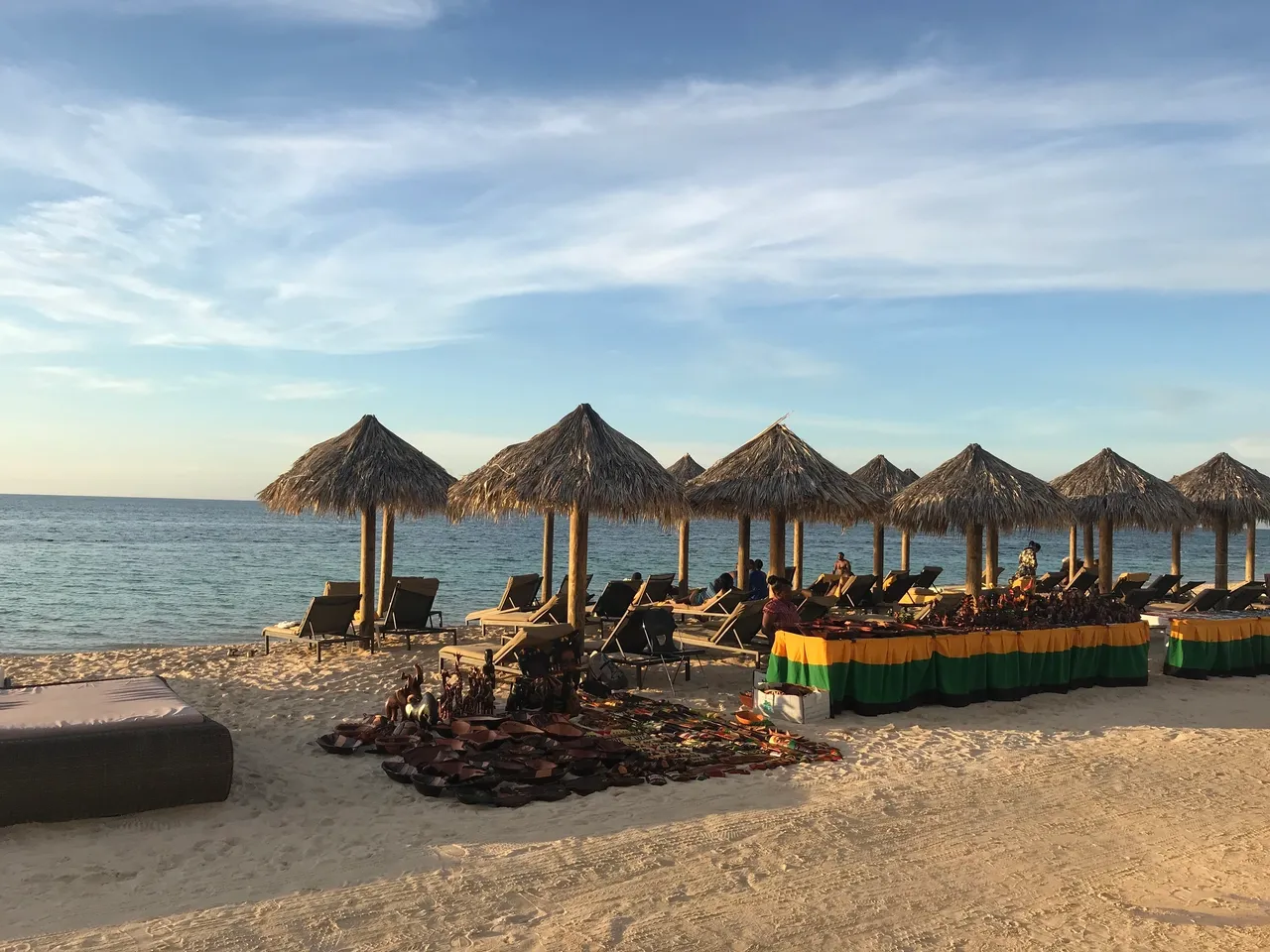 Beach with umbrellas and lounge chairs.