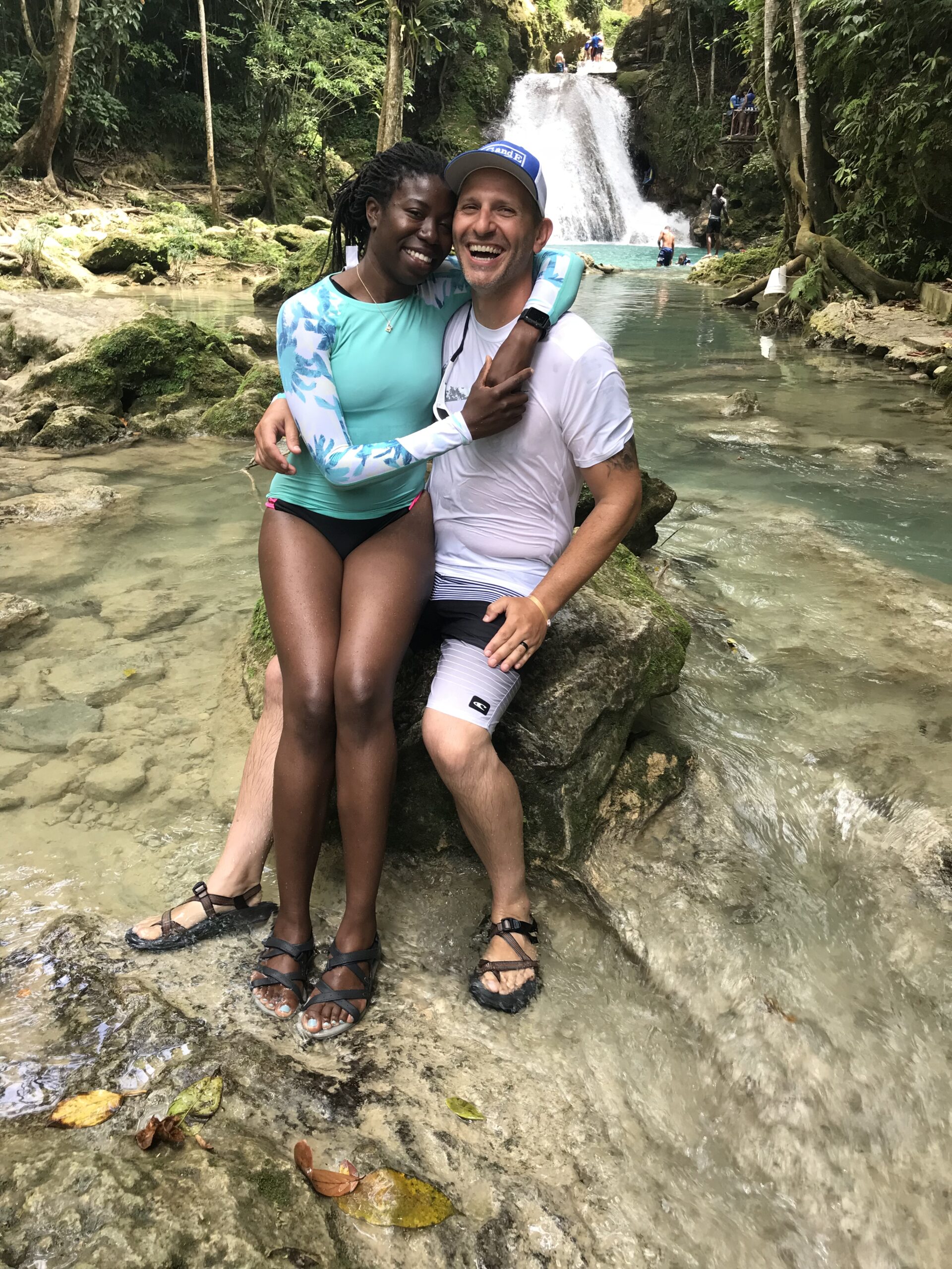 Couple laughing at a waterfall excursion in Jamaica