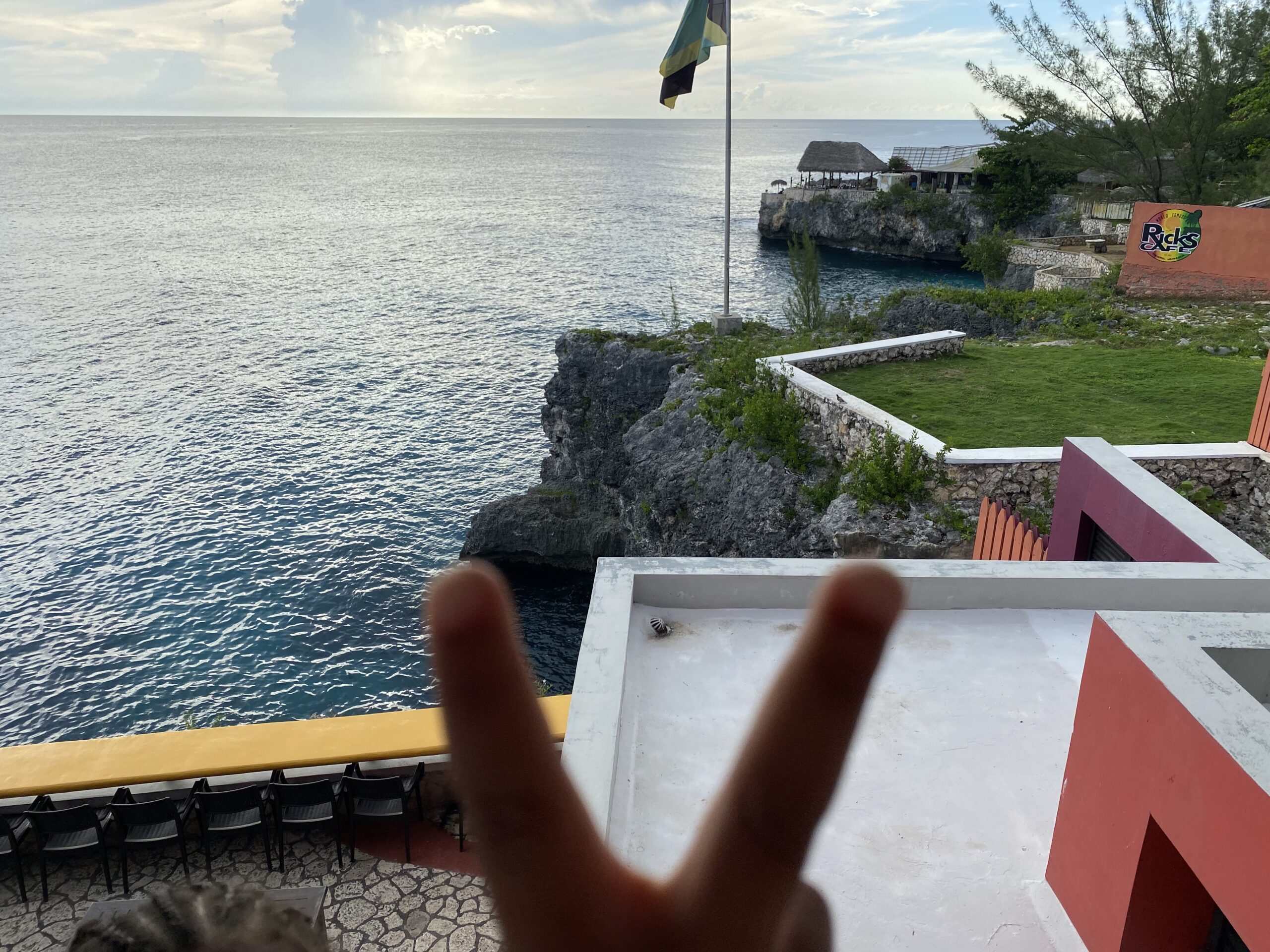 View from Rick's Cafe cliffs in Negril, Jamaica with Jamaican flag