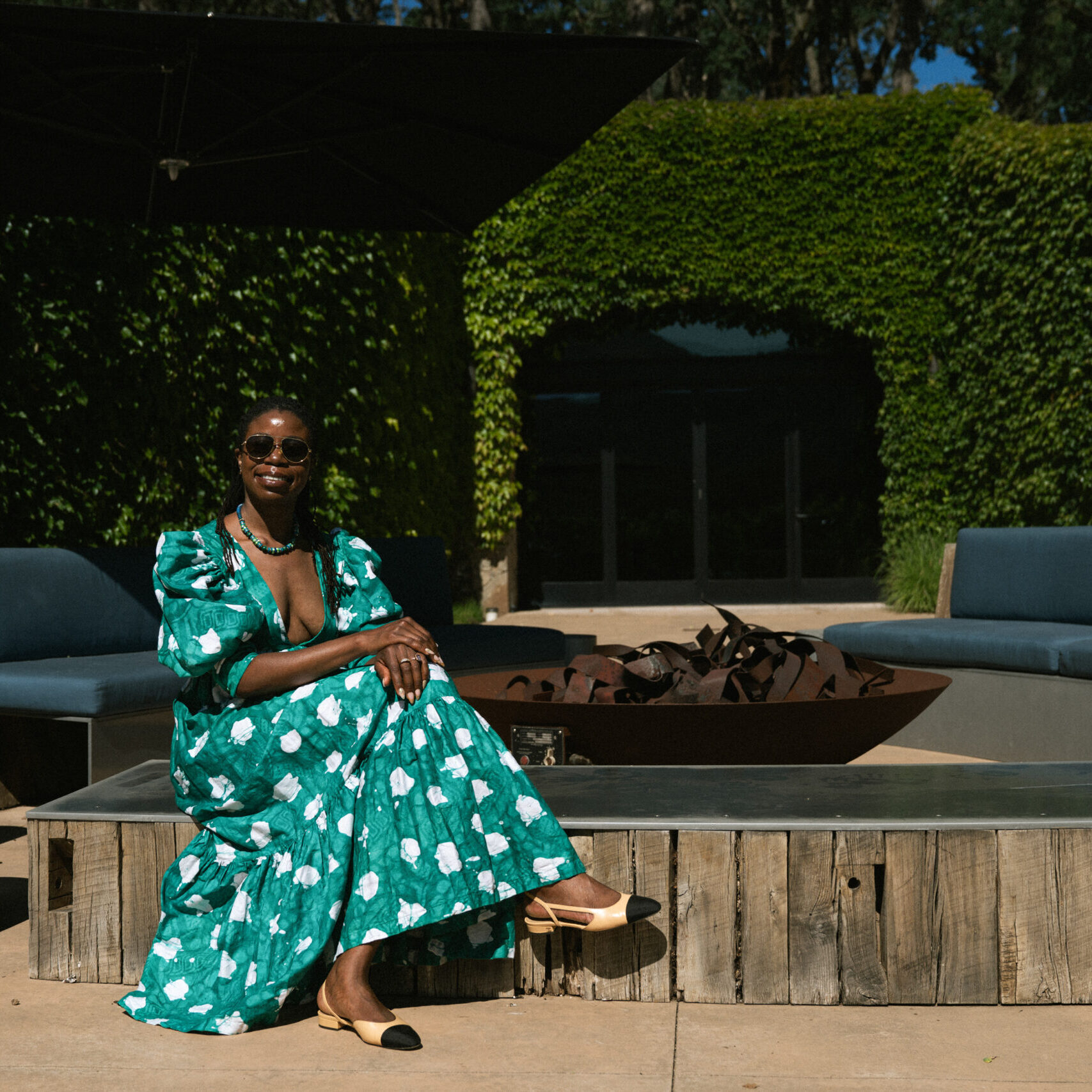 Founder Sheba Sawyer posing next to a fireplace