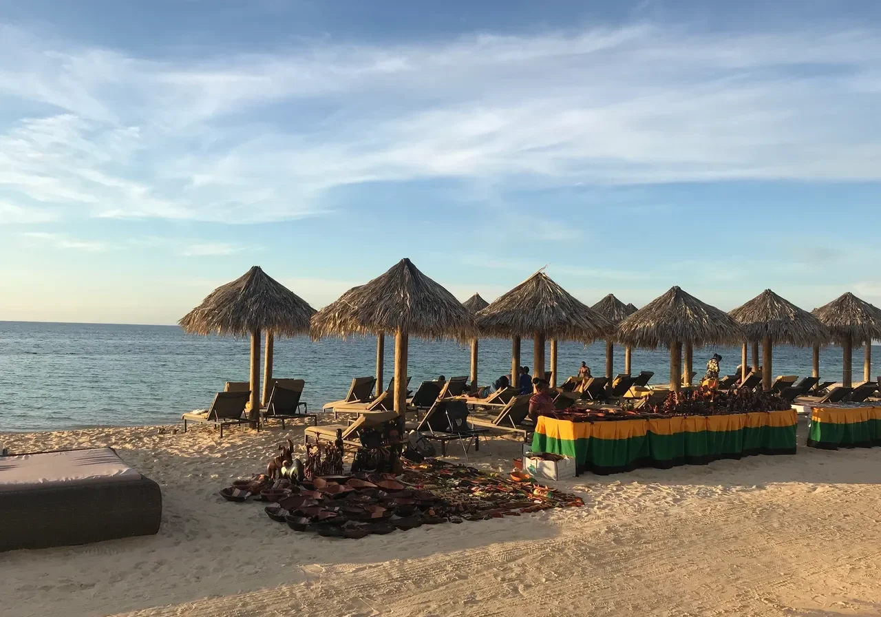 Beach with umbrellas and lounge chairs.